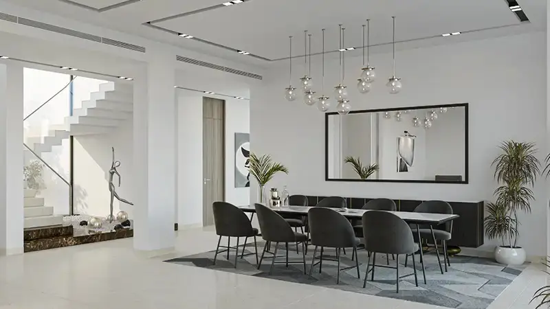 Grand double height living room interior featuring floor to ceiling windows at Ain Al Maha luxury villas Jubail Island