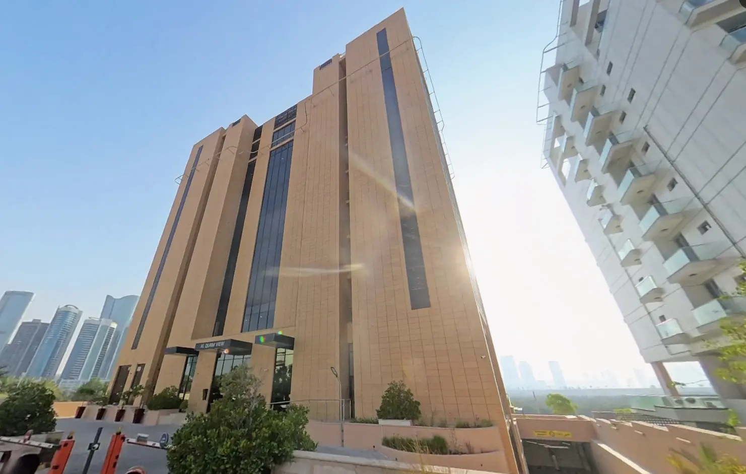 Aerial exterior view of Al Qurm View property surrounded by lush green parks and waterfront skyline on Al Reem Island