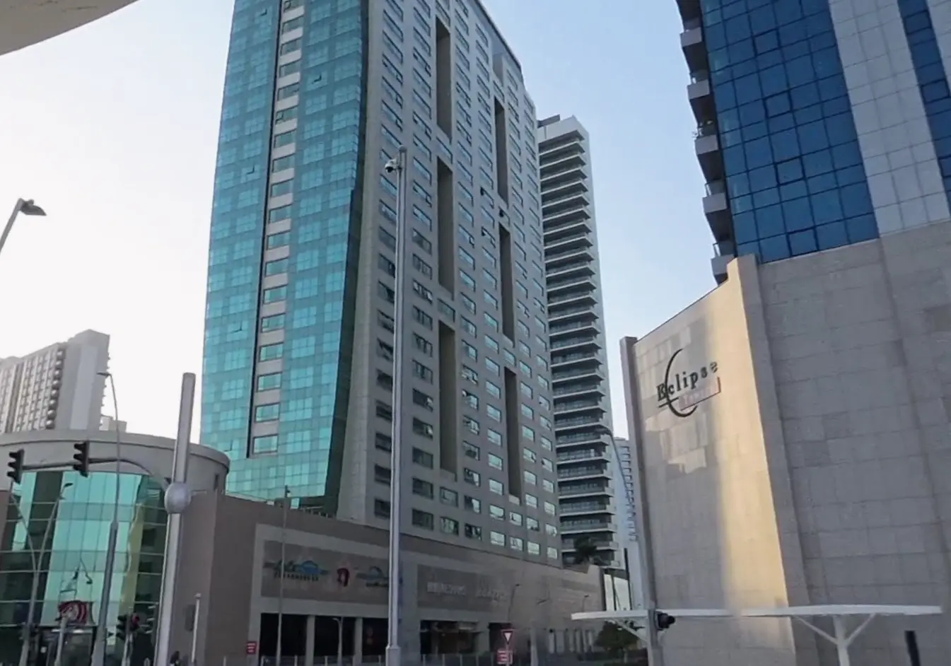 Street-level podium entrance and ground floor retail space at Burj Al Shams building in Al Reem Island