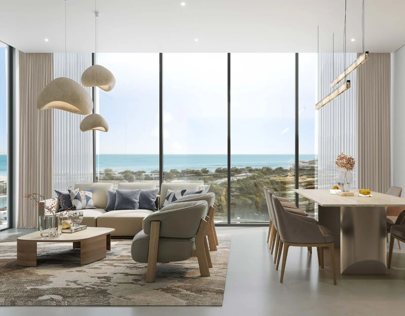 Sunlit luxury living and dining room with floor to ceiling sea views at Capeside Marina Residences Sobha Siniya Island Umm Al Quwain.