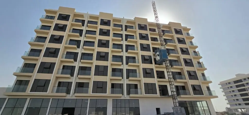Gated entry plaza and modern facade of Reeman Garden 1 residential apartments in Al Shamkha Abu Dhabi