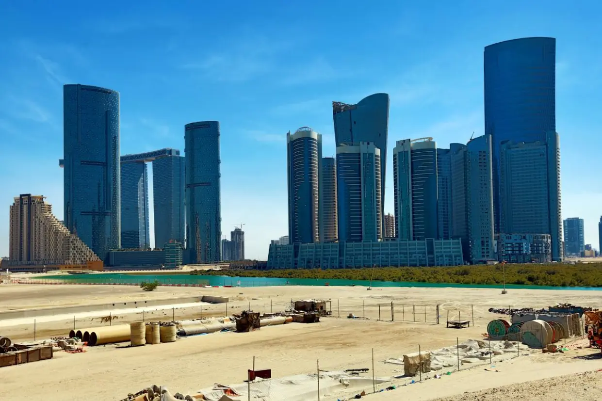 Abu Dhabi Marina Spirit City of Lights skyline with glass skyscrapers overlooking construction site and waterfront development zone.