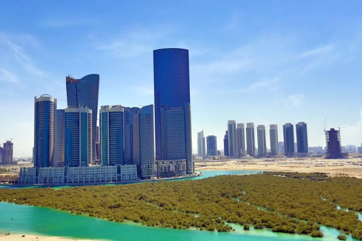 Abu Dhabi Marina Spirit City of Lights skyline featuring reflective glass towers beside turquoise water and preserved mangrove landscape.