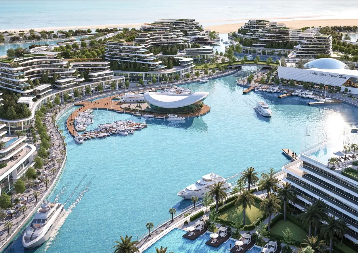 Aerial view of luxury yacht marina, retail mall, and modern residential towers at Bayfront Marina Residences