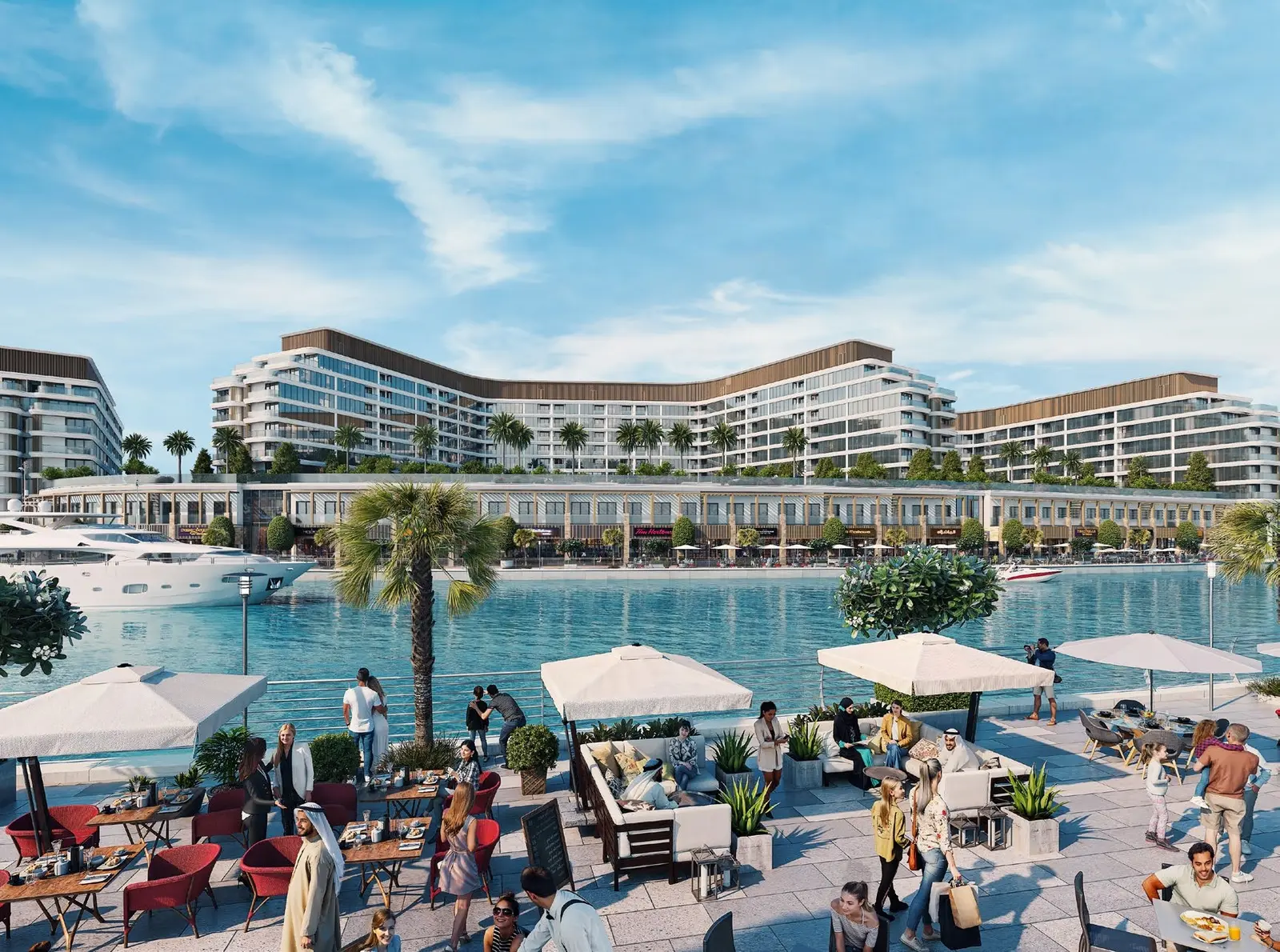 Outdoor dining terraces and leisure promenade facing the water canal at Bayfront Marina Residences Umm Al Quwain