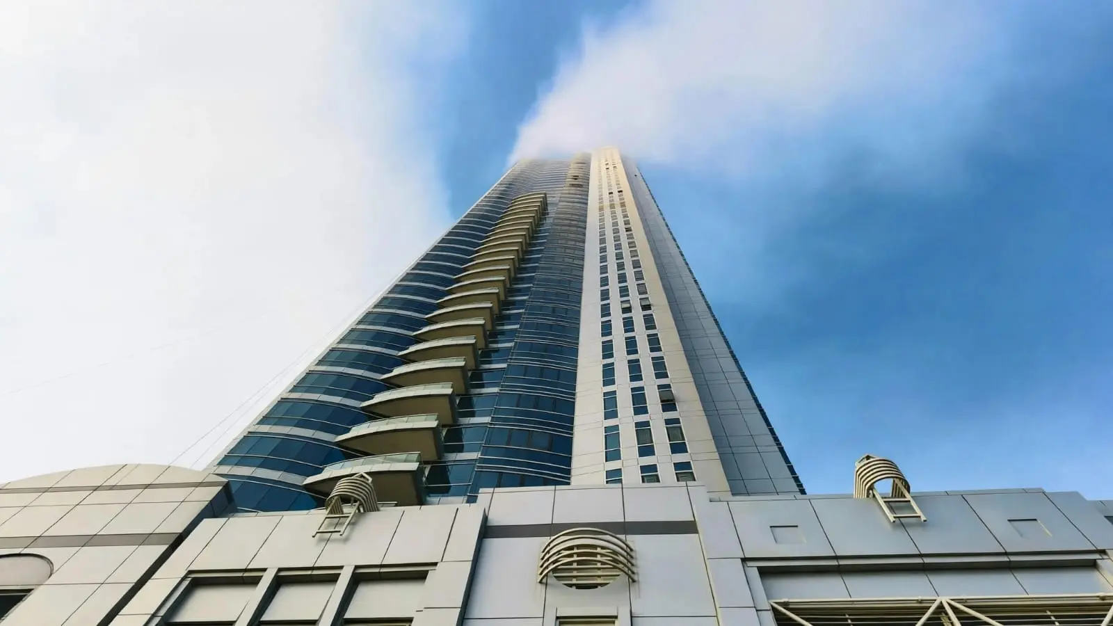 Al Muhaimat Tower front exterior showcasing elegant architecture and urban residential living in Najmat Abu Dhabi, UAE.