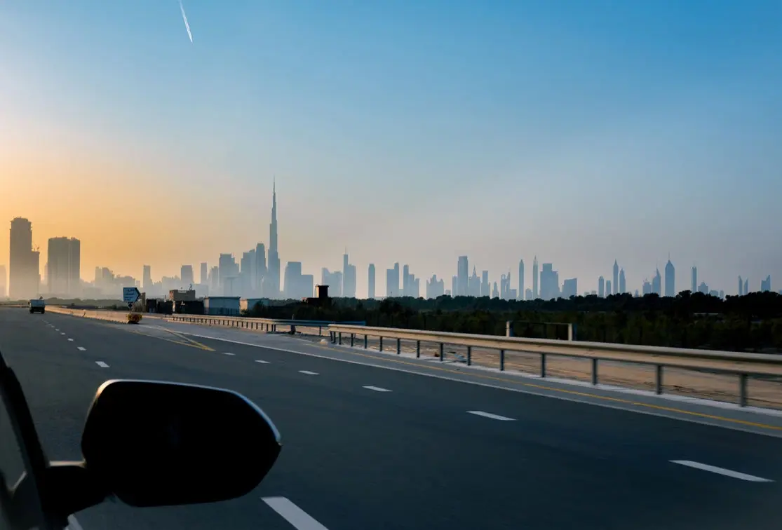 View of the highway and city skyline during a scenic road trip near Bayside Marina Residences on Sobha Siniya Island