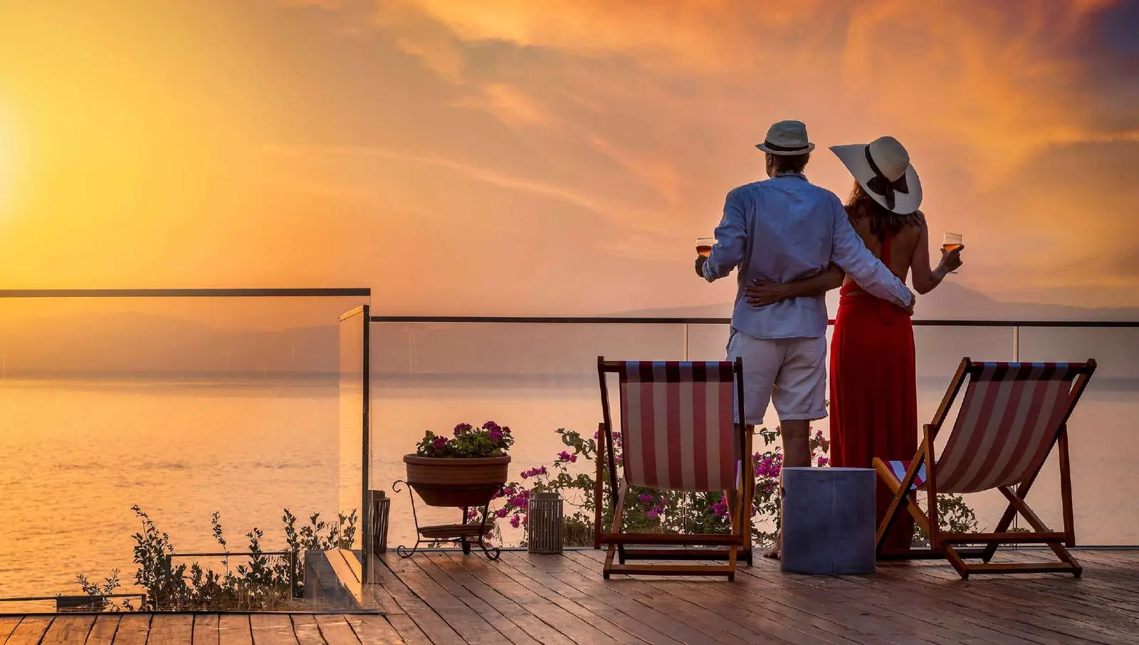 Resident terrace deck with loungers overlooking sunset ocean vistas at Pierside Marina Residences Sobha Siniya Island UAQ