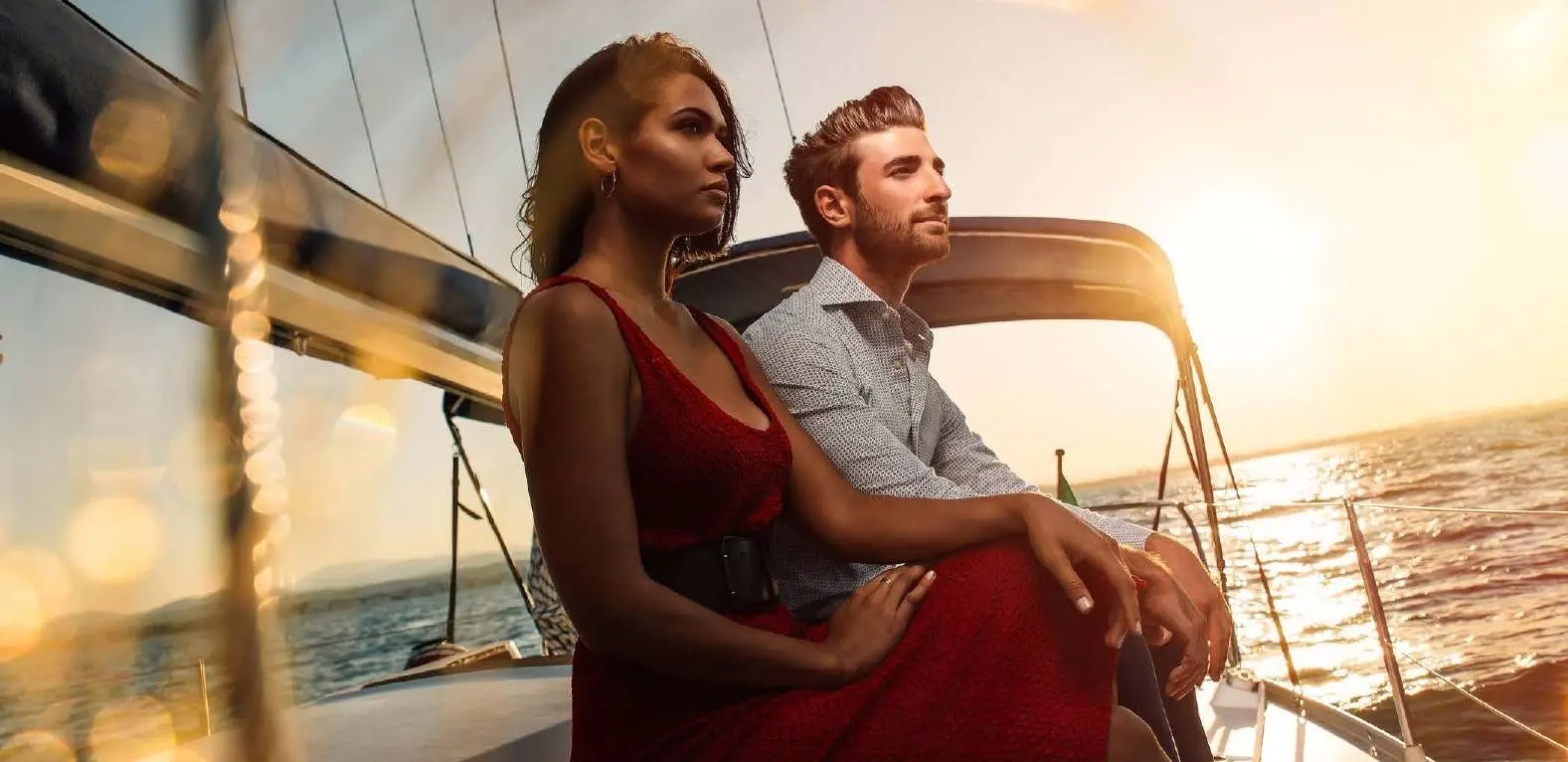 Couple enjoying sunset cruise experience on a luxury yacht near Pierside Marina Residences Sobha Siniya Island UAQ