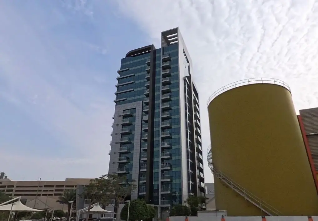 Modern glass facade exterior view of Al Noor Tower residential high rise building on Al Reem Island Abu Dhabi.