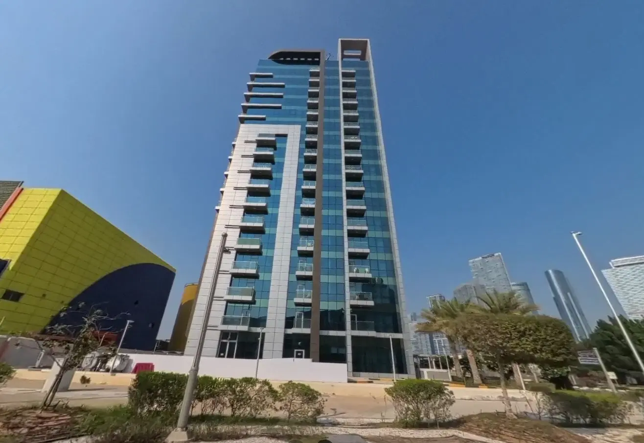 Street level architectural view showing the entrance podium of Al Noor Tower in Tamouh district Al Reem Island.