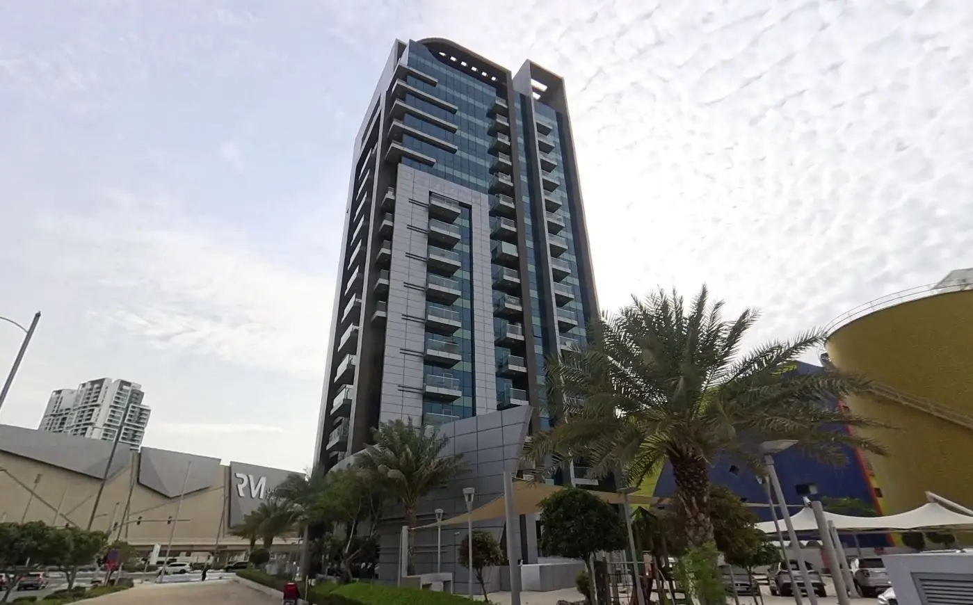 Exterior architectural detail and landscaped podium level of Al Noor Tower built by Bainona Engineering Consultancy Abu Dhabi.