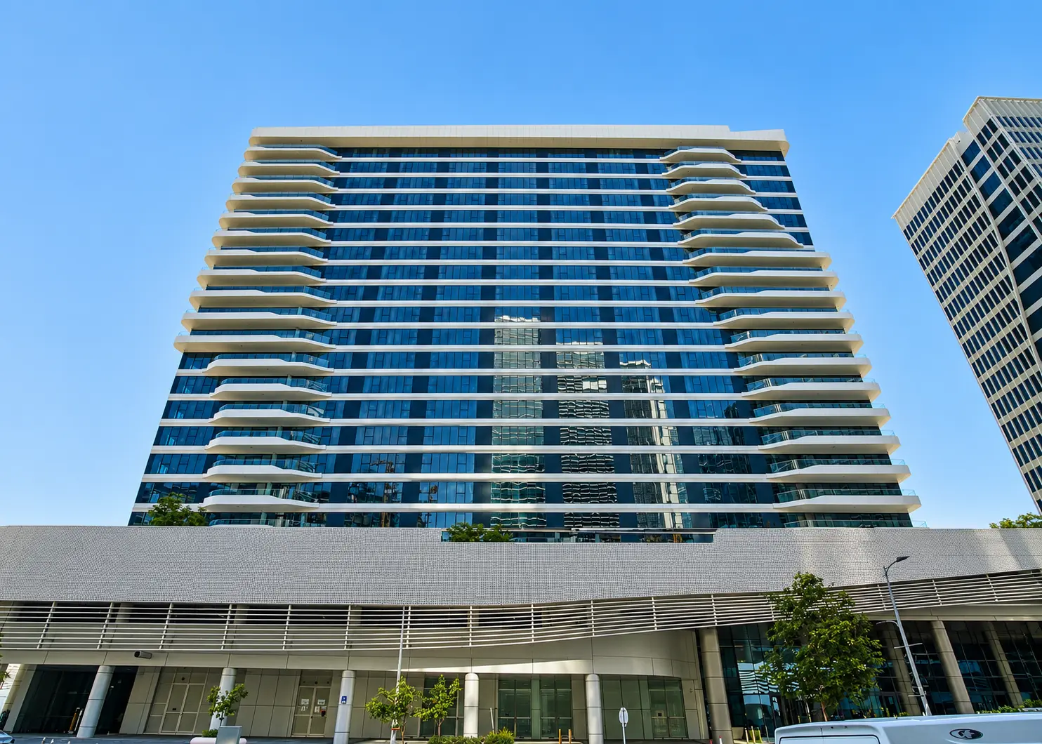 Modern Glass Tower Under Blue Skies