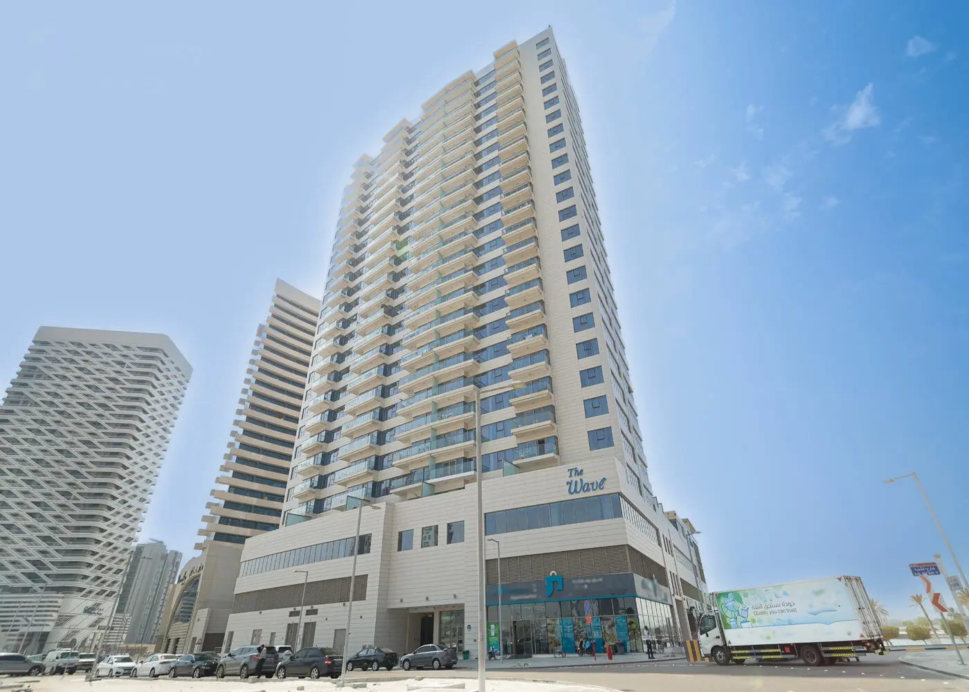 Modern high-rise residential exterior showcasing curved glass architecture at The Wave in Al Reem Island Abu Dhabi