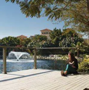 Residents enjoying lifestyle amenities at The Reserve Al Barari Dubai luxury villa community with tennis courts.jpg