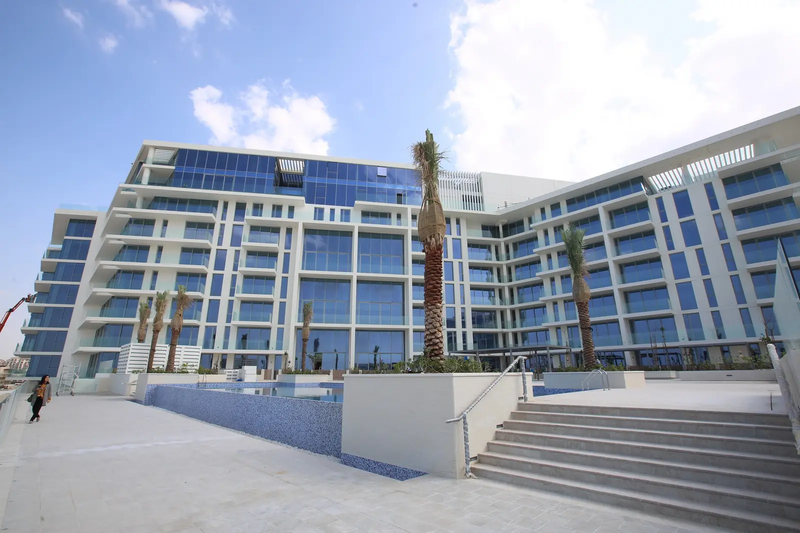 Private penthouse rooftop with infinity pool, sun deck, and panoramic sea and museum views