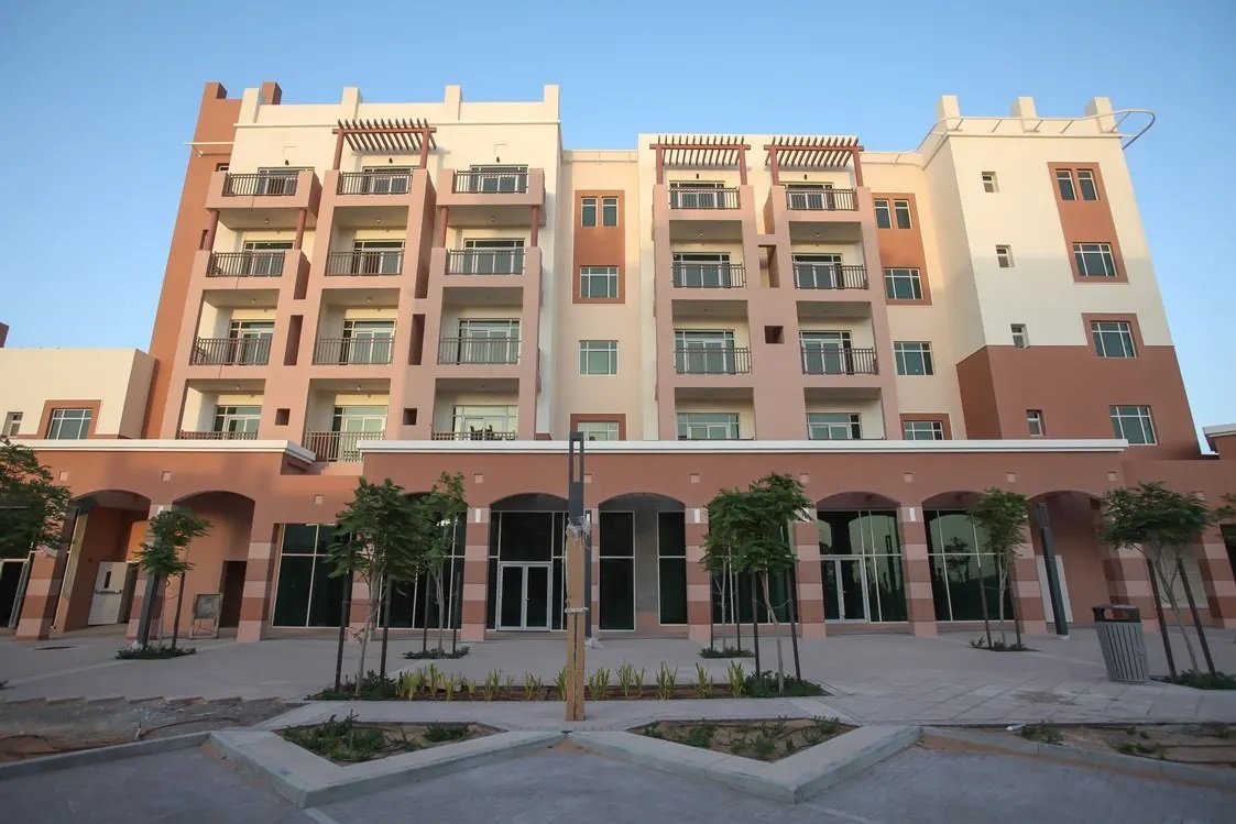 Apartments in Al Ghadeer Abu Dhabi, UAE surrounded by shaded walkways and beautifully maintained community gardens.jpg